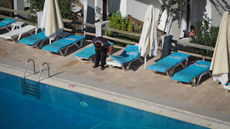 Inviting outdoor pool area with sun loungers and turquoise water reflecting the Mediterranean sun.