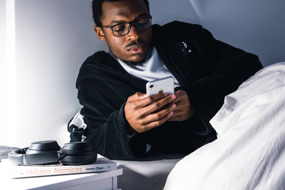 man in black jacket wearing black framed eyeglasses