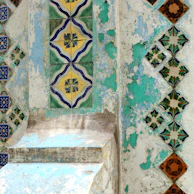 Close-up of intricate Peranakan tile patterns on a heritage building wall.