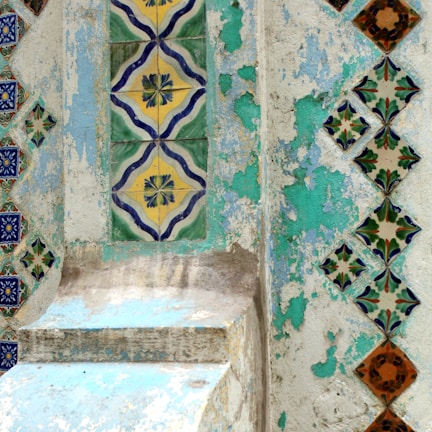 Close-up of a decorative plaster tile with intricate floral patterns.