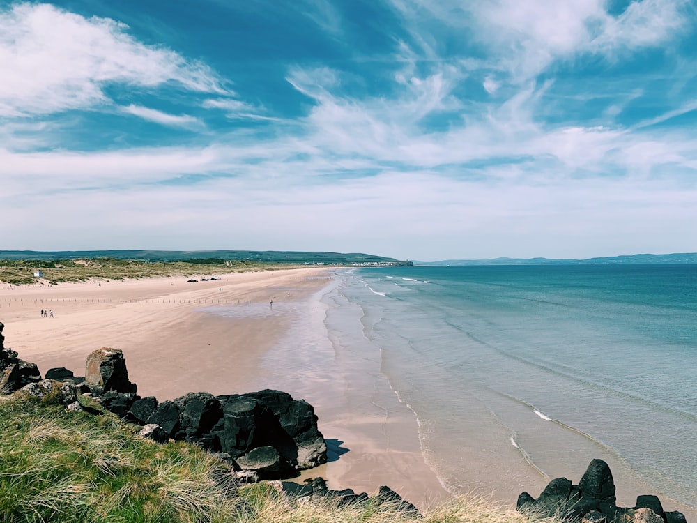 brown sand beach under blue sky during daytime