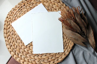 Close-up of a placemat made of natural woven fibers on a wooden table.