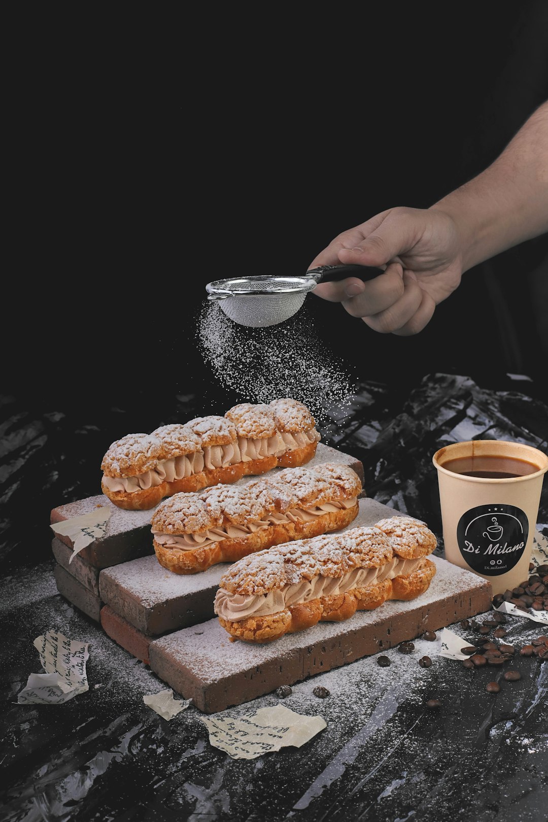 person holding stainless steel spoon and white ceramic mug with coffee