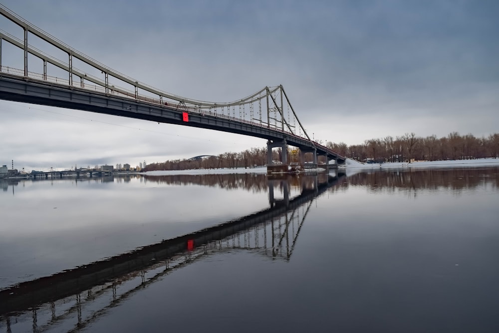 bridge over the lake under white clouds