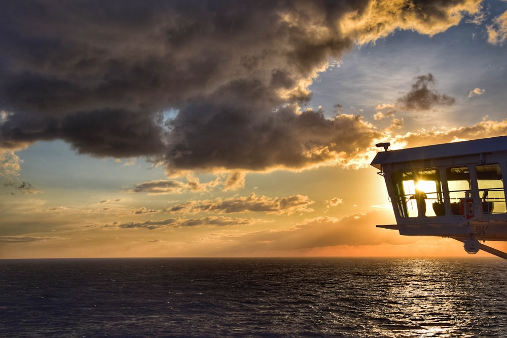 silhouette of a building on a beach during sunset