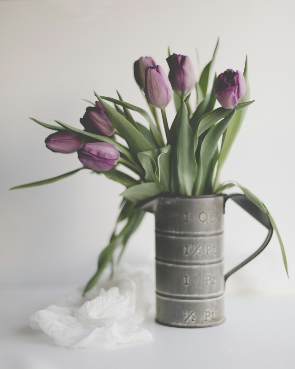 purple tulips in gray steel mug