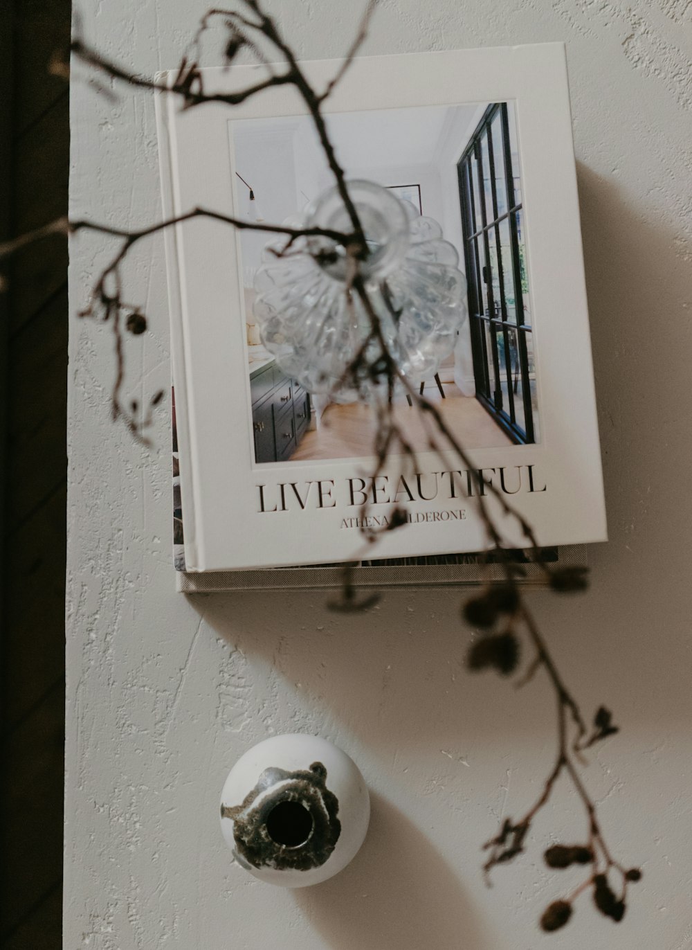 a book sitting on top of a white wall