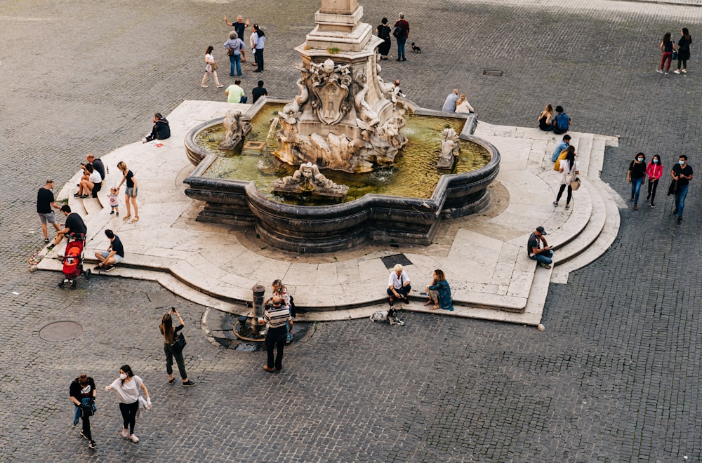 people walking on street with gold statue