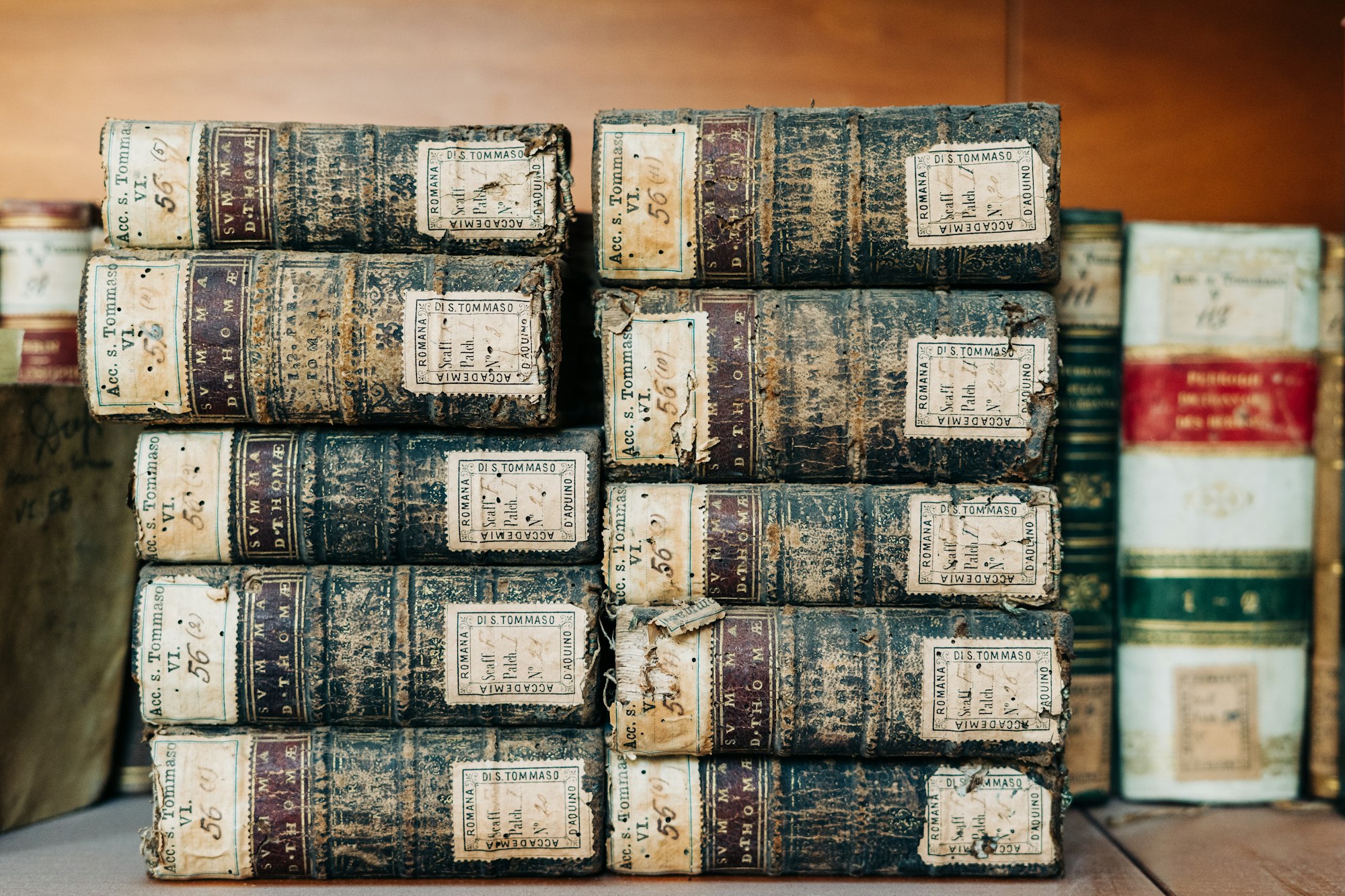 A stack of antique books on a shelf