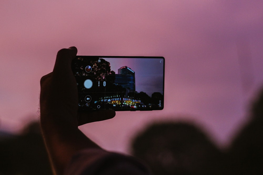 person holding black android smartphone