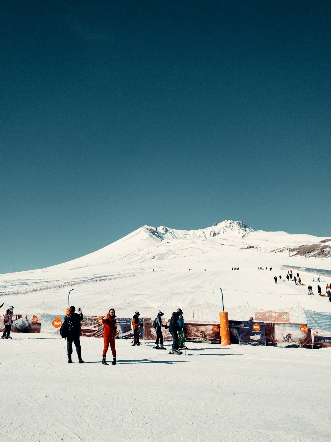 people standing on snow covered ground during daytime