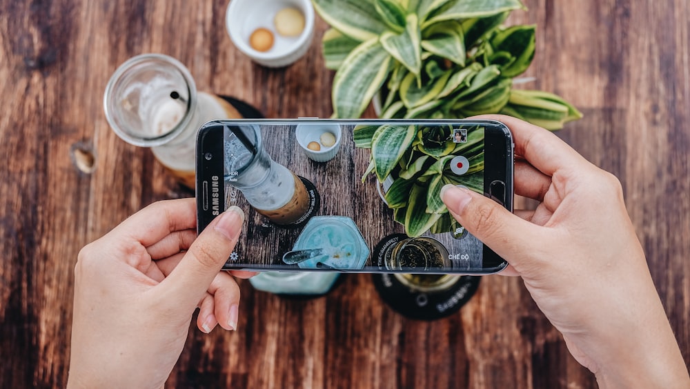 person holding silver iphone 6