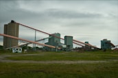 A wide shot of conveyor belts moving products inside a busy manufacturing plant.