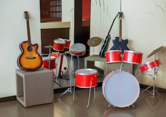 brown acoustic guitar on gray steel stand