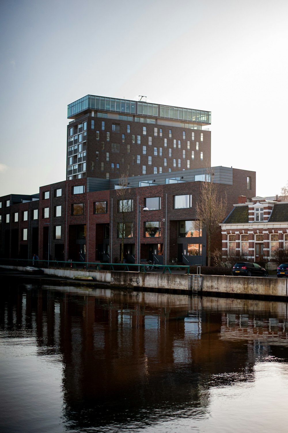 brown concrete building near body of water during daytime