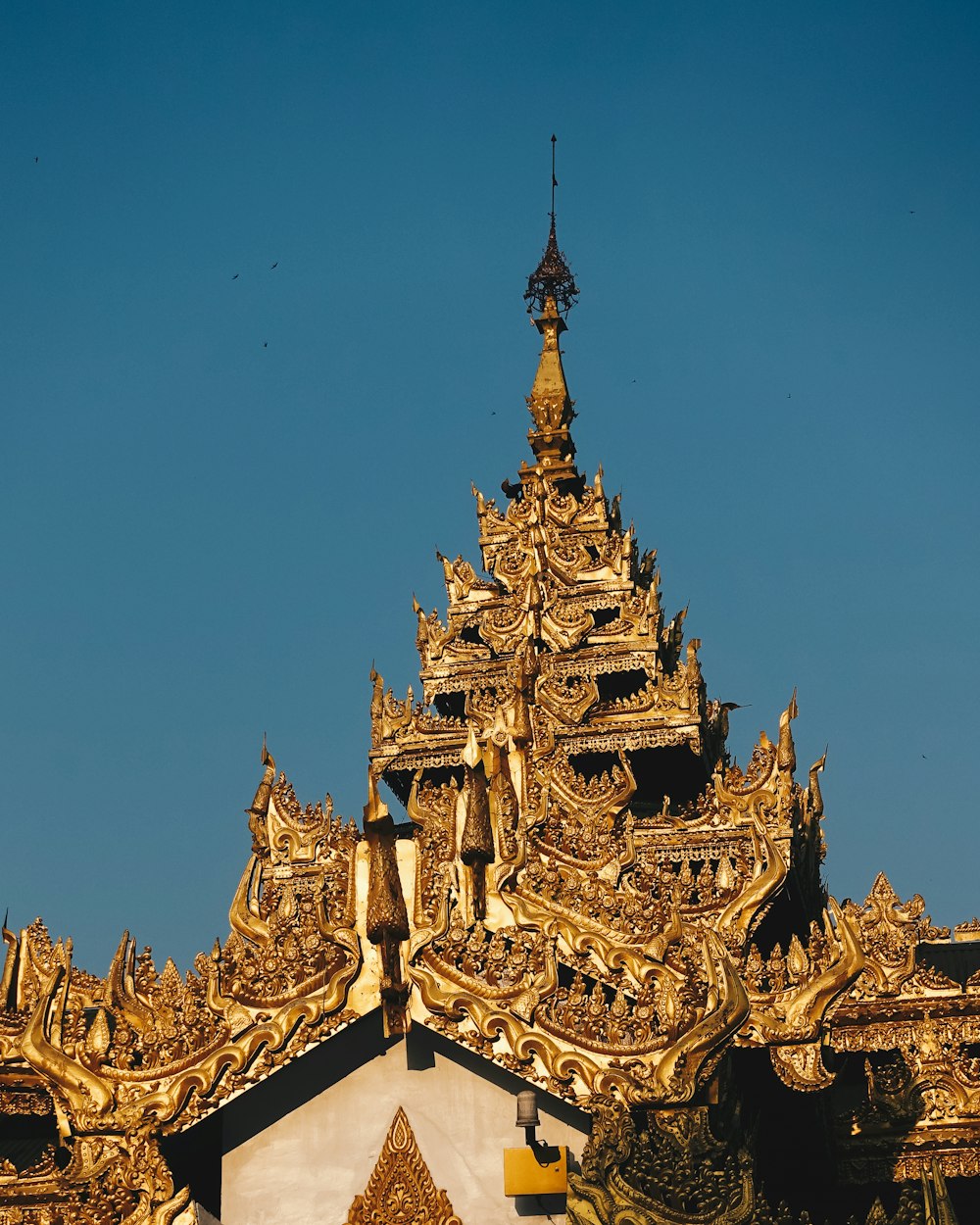 gold and black temple under blue sky