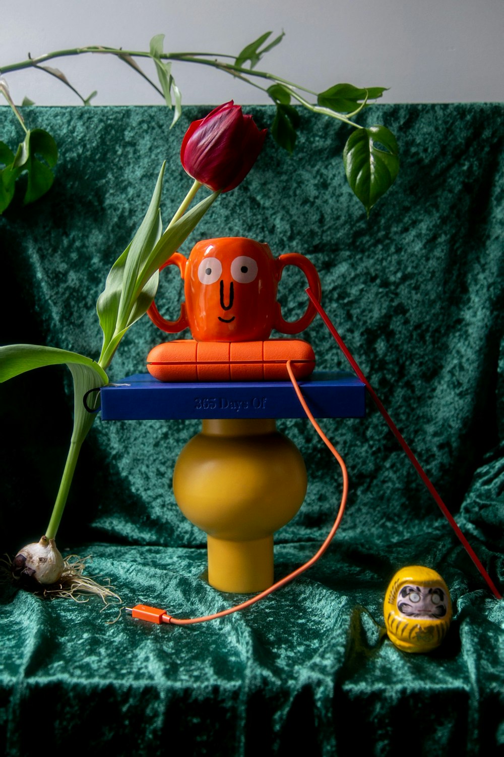 yellow and red plastic toy on green leaves