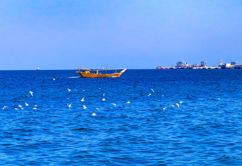 brown boat on blue sea during daytime