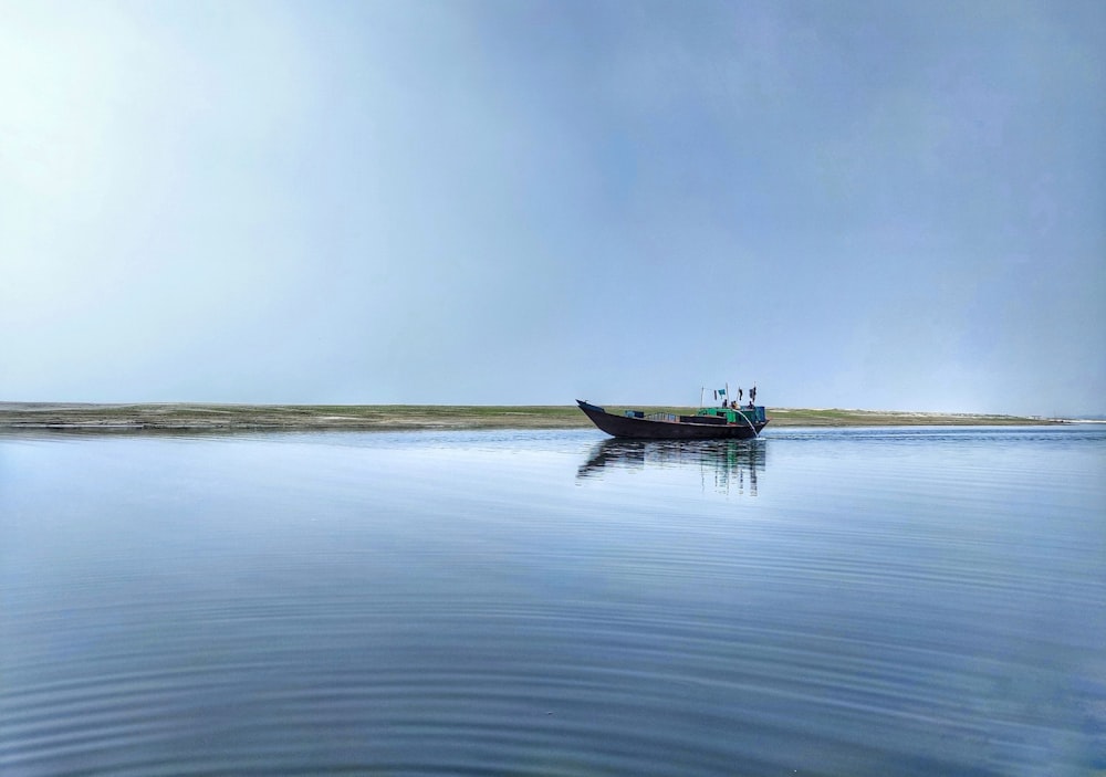 boat on sea under gray sky