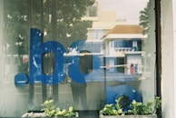 Close-up of a window decal featuring crisp vinyl lettering on a glass door, reflecting the Calgary skyline.