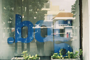 A sparkling clean storefront window reflecting the street and sky.