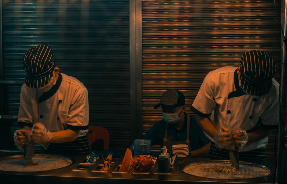 man in white shirt standing near table