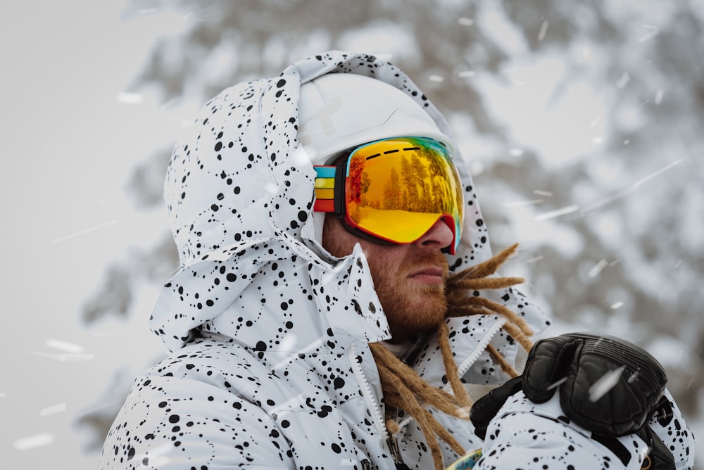 man in white and black floral robe wearing yellow sunglasses