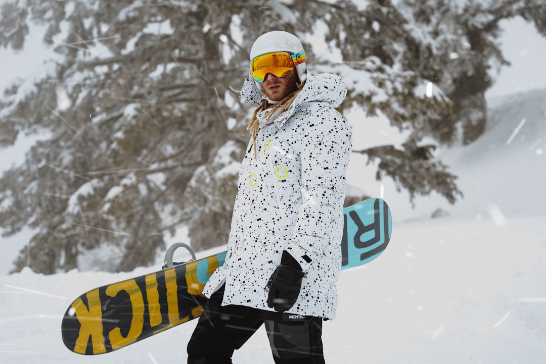woman in white and black floral coat and black pants standing on snow covered ground during, Vacation