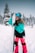 a woman holding a snowboard in the snow