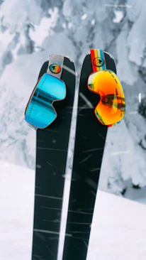 red and yellow snowboard on snow covered ground