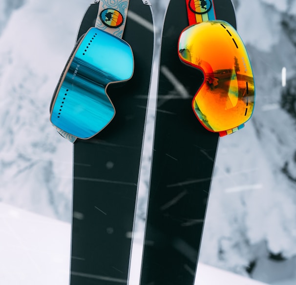 red and yellow snowboard on snow covered ground