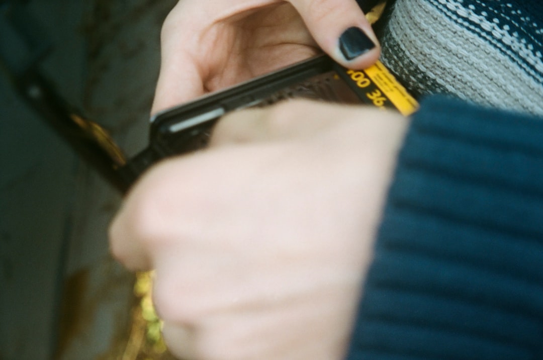 person holding black and yellow hand tool