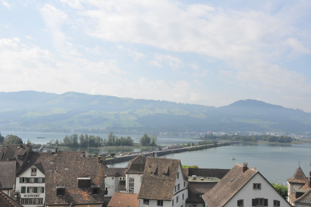 brown and white concrete houses near body of water during daytime