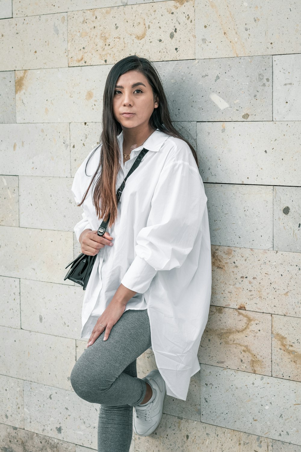 woman in white coat sitting on gray chair