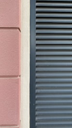Before and after images of a house facade showing fresh plaster and new paint.