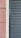 A close-up view of a building facade features a section of textured pinkish-brown plaster next to a cream-colored surface. Adjacent to these is a set of dark gray louvered shutters, creating a stark contrast between the smooth, modern surface and the textured, traditional wall.