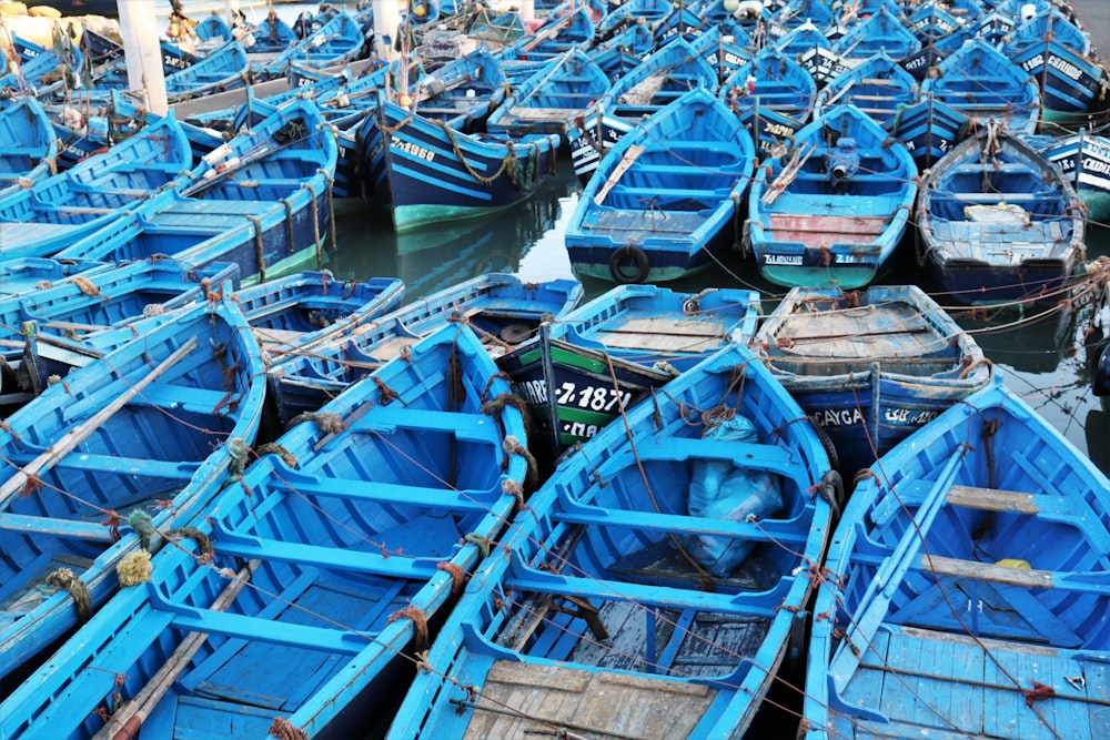 blue and brown wooden boats on body of water during daytime