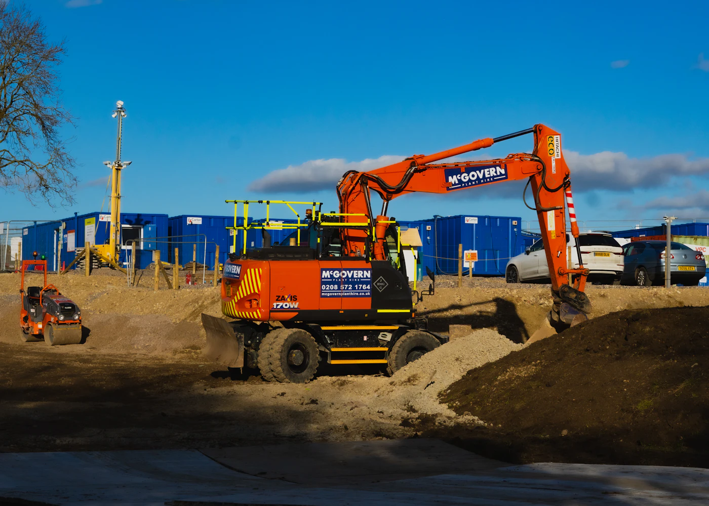 Excavator carrying out earthworks on a cleared site