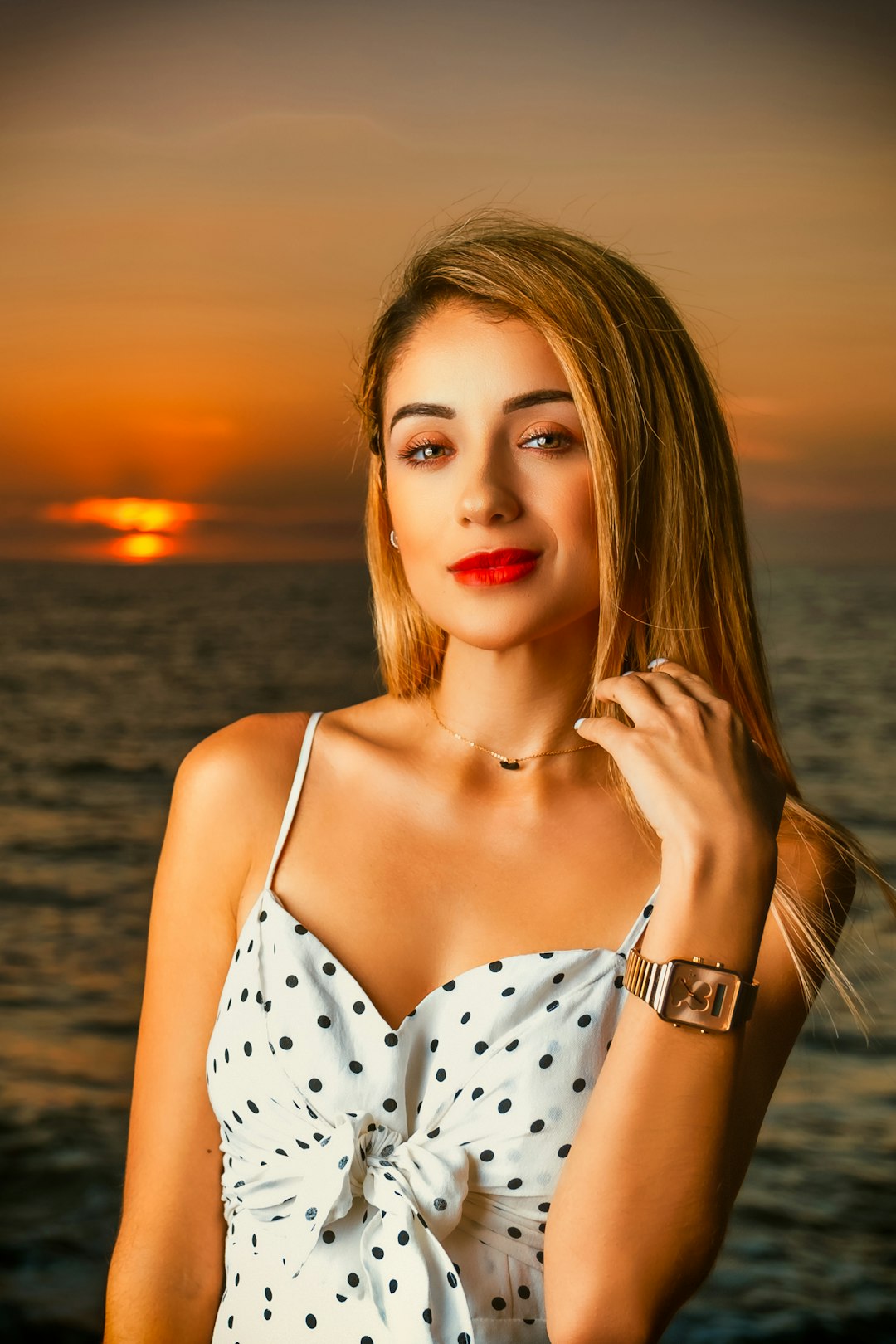 woman in white and black polka dot spaghetti strap top