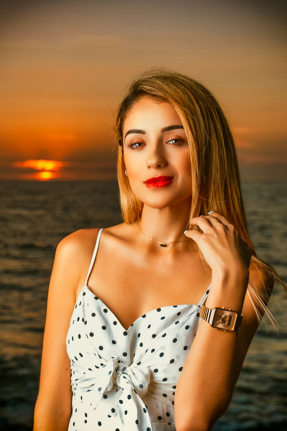 woman in white and black polka dot spaghetti strap top