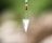 silver diamond pendant with red blue and yellow beads