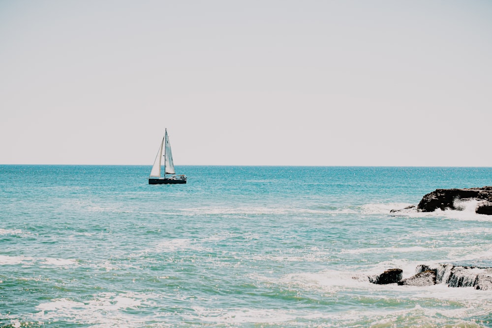 white sailboat on sea during daytime