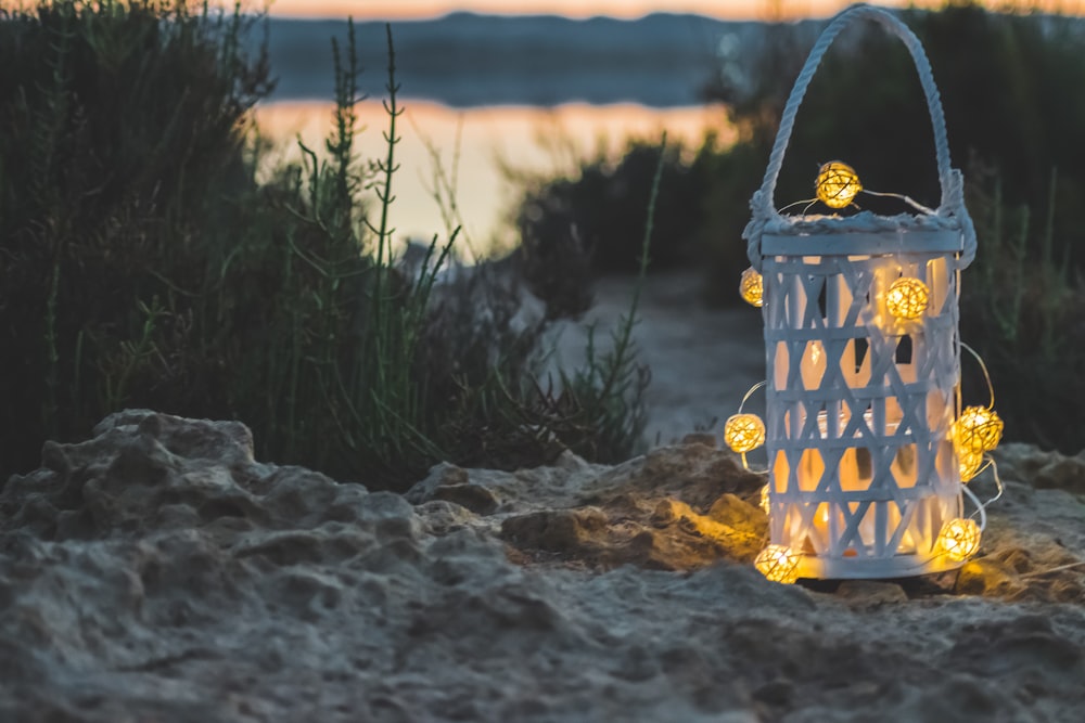 yellow candle lantern on brown sand