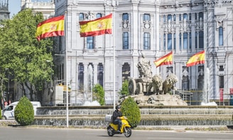 man in yellow and black motorcycle with black helmet riding motorcycle on road during daytime
