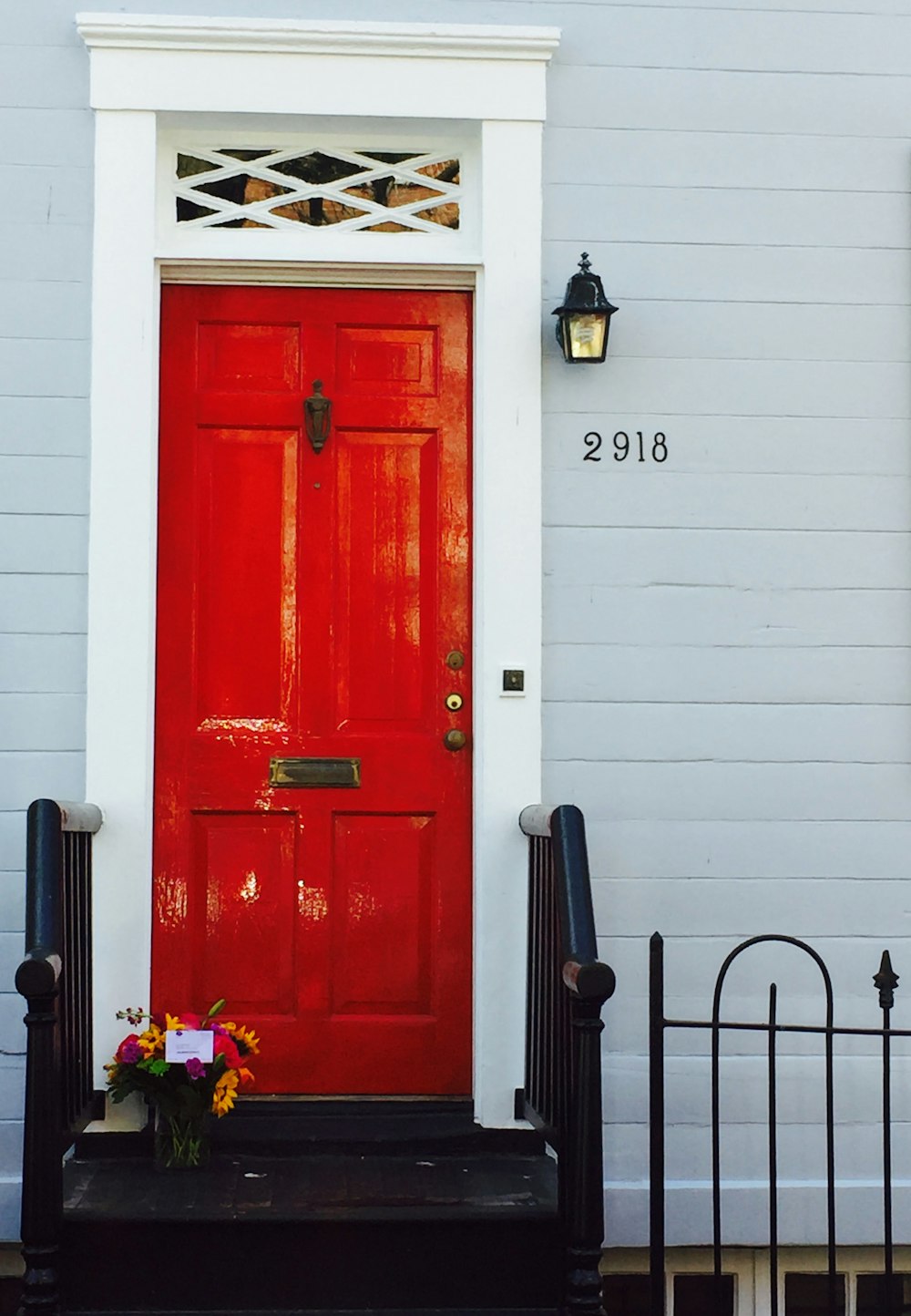red wooden door with gold door lever