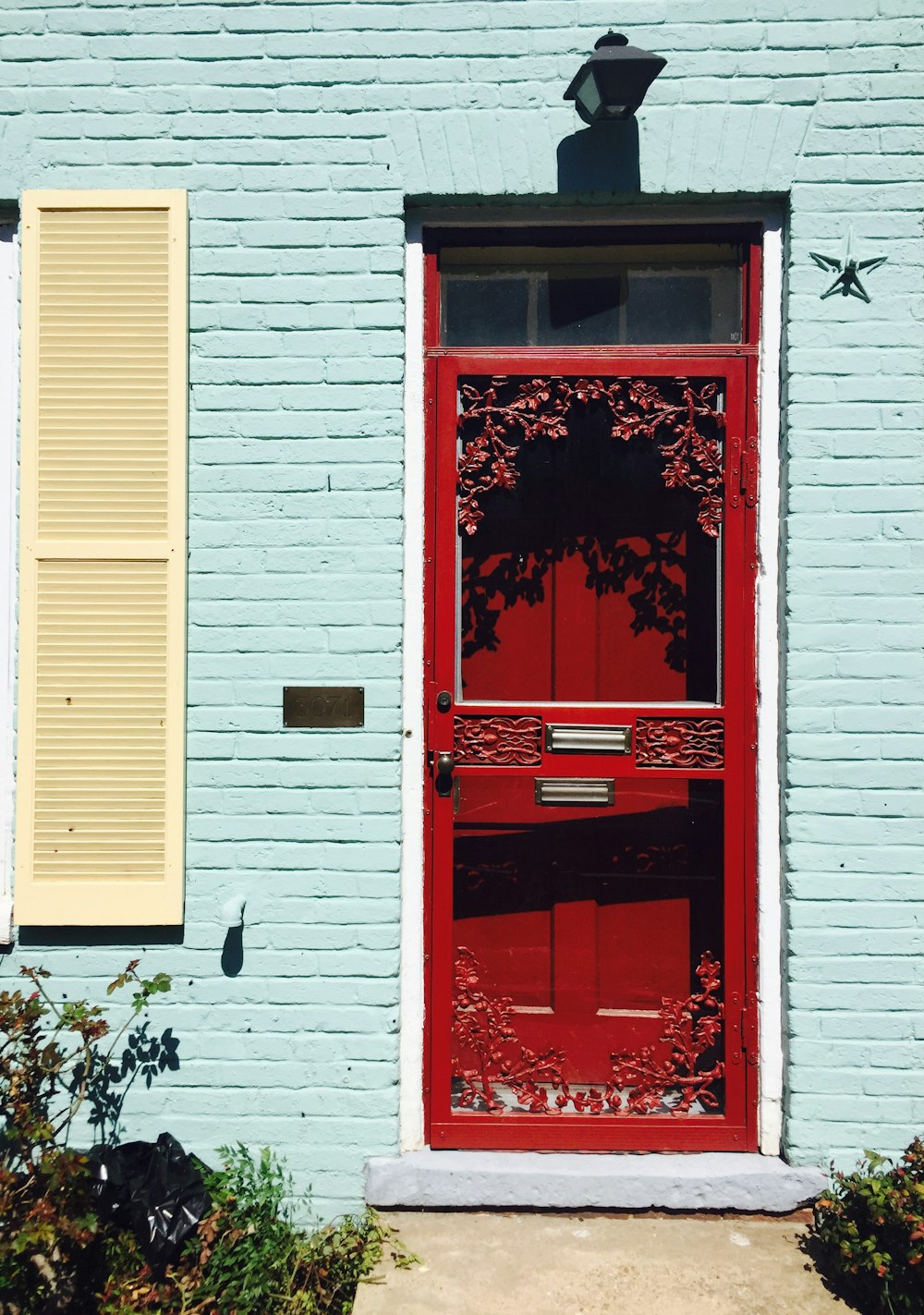 red wooden door with white wooden door