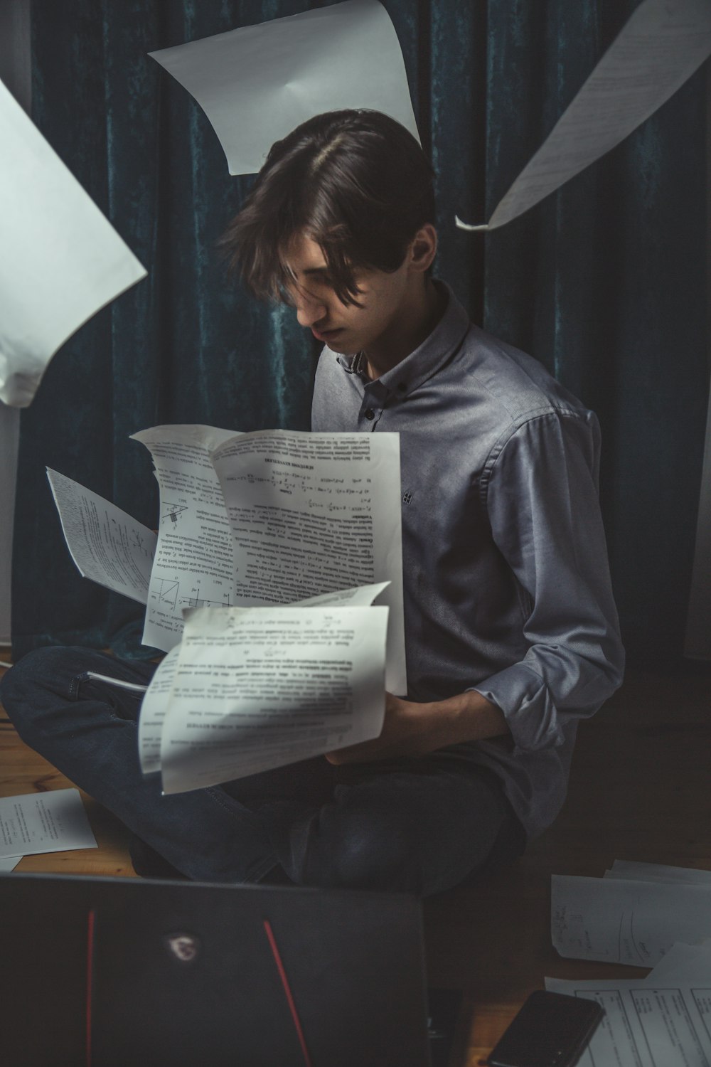 woman in blue dress shirt reading book