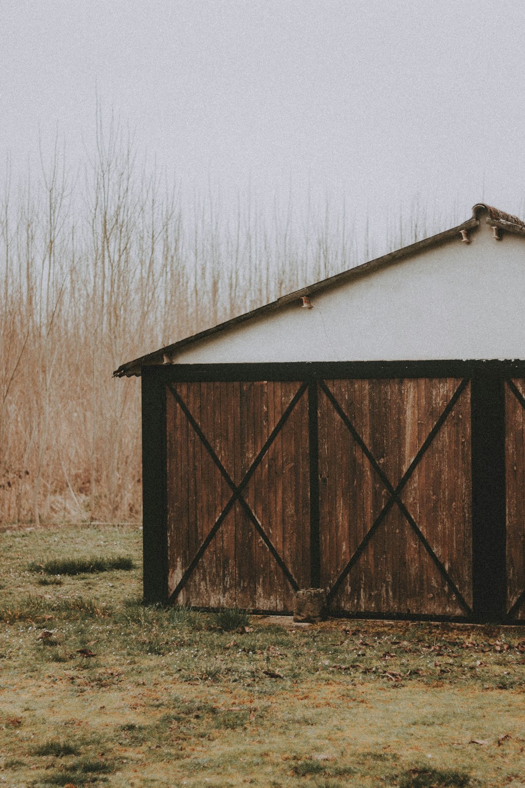 brown and white wooden shed on green grass field