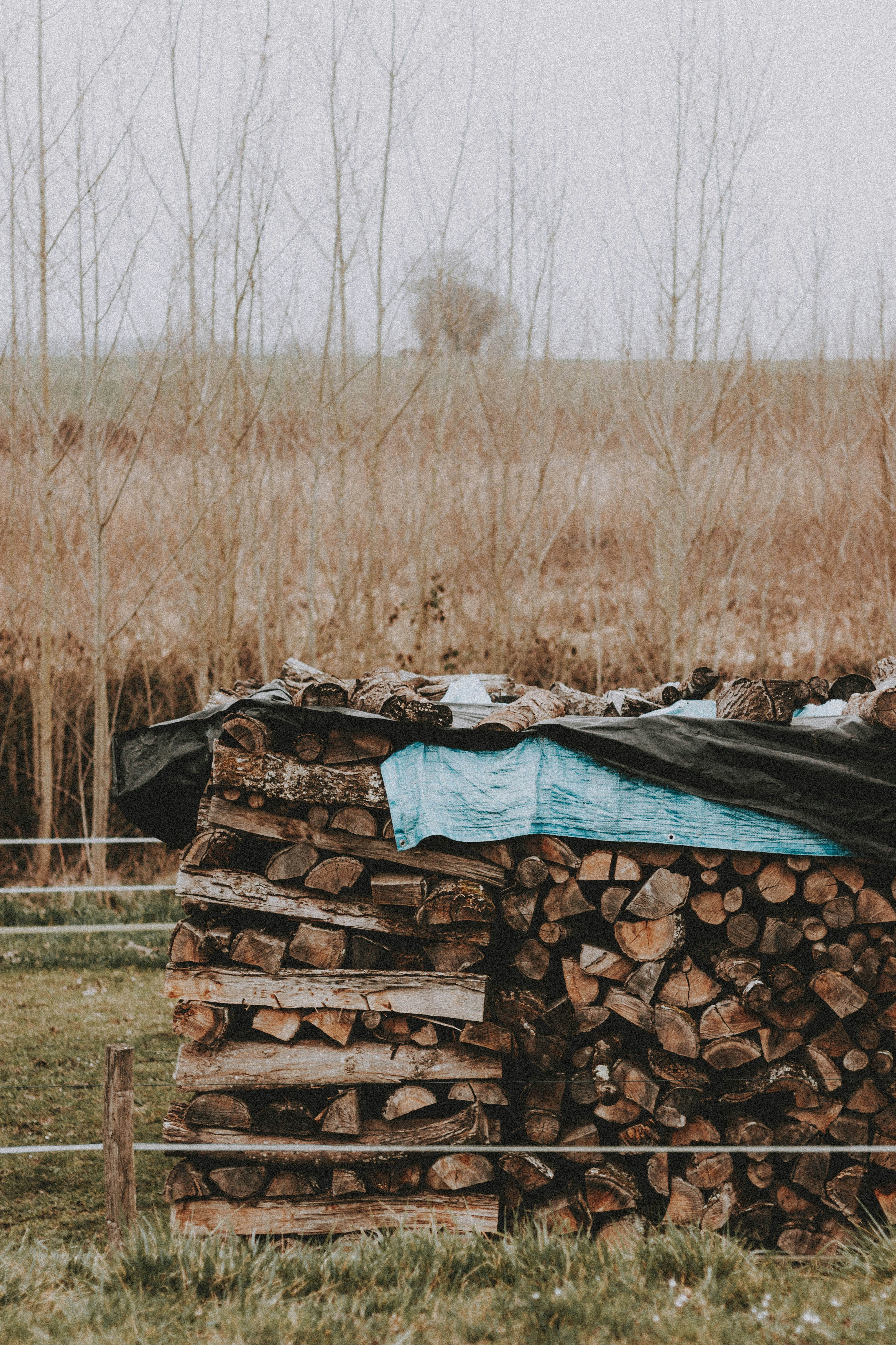 stack of blue and brown textiles on brown wooden log