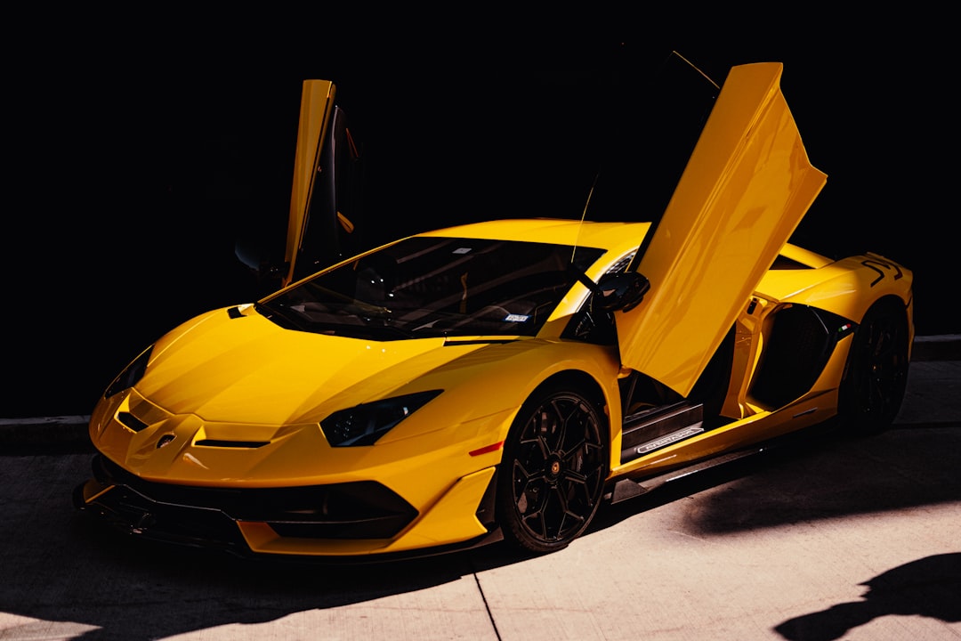 yellow ferrari 458 italia on black background, Lamborghini Aventador SVJ in the shadows<p></figure>